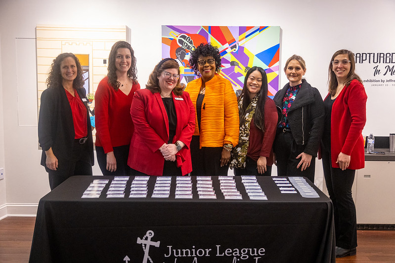 7 women posing behind a table