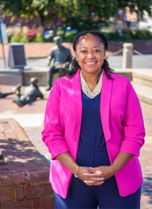 black woman with bright pink blazer