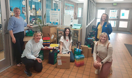 Ladies posing with donations